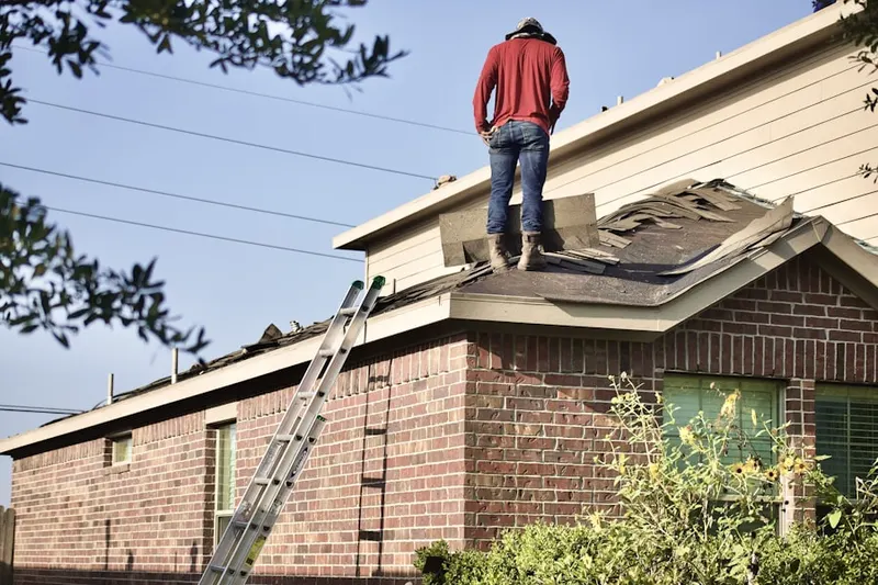 Professional roofer working on a residential roof in Mecox